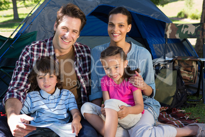 Happy family on a camping trip in their tent