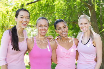 Smiling women in pink for breast cancer awareness