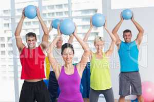 Instructor with class exercising with fitness balls