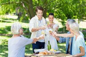 Happy couple toasting with their family