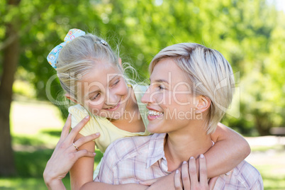 Pretty blonde with her daughter in the park