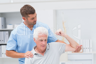 Physiotherapist giving physical therapy to man