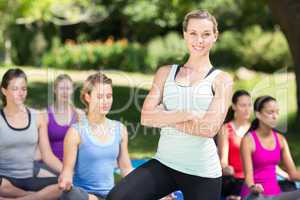 Fitness group doing yoga in park