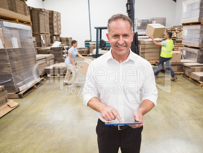 Manager using digital tablet during busy period