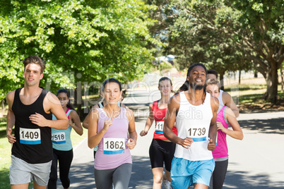 Fit people running race in park