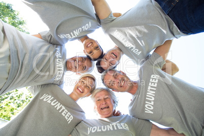 Happy volunteer family looking down at the camera