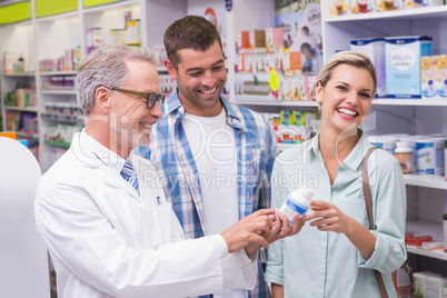 Pharmacist and costumers smiling