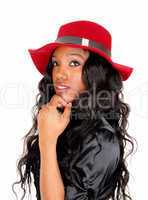 Closeup of black woman with red hat.