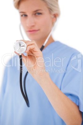 Blonde doctor listening with stethoscope