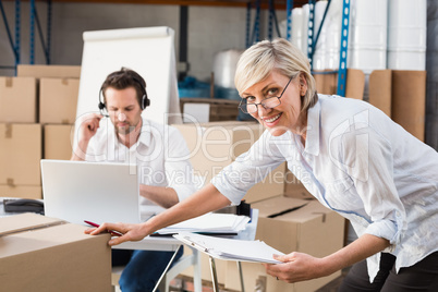 Warehouse manager checking her inventory