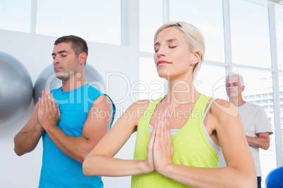 People meditating in gym class