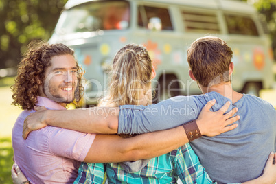 Hipster smiling at camera with friends