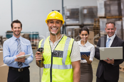 Worker standing with scanner in front of his colleagues