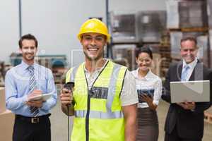 Worker standing with scanner in front of his colleagues