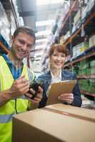 Worker and manager scanning package in warehouse