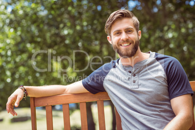 Young man relaxing on park bench