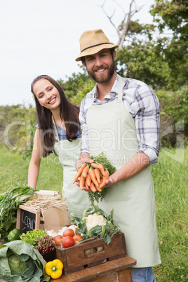 Couple selling organic vegetables at market
