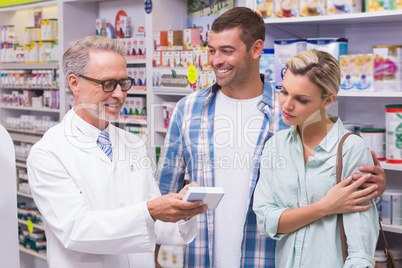 Pharmacist and costumers smiling