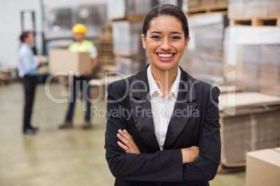 Female manager with arms crossed in warehouse