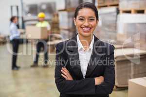 Female manager with arms crossed in warehouse