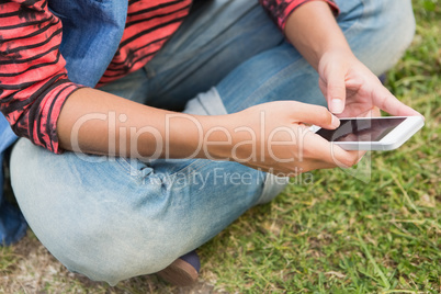 Woman texting in the park