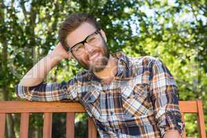 Handsome hipster relaxing in the park