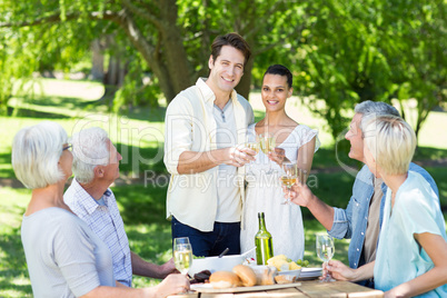 Happy couple toasting with their family