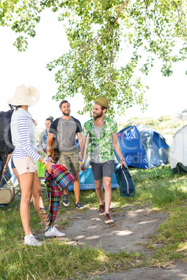 Excited friends arriving at music festival