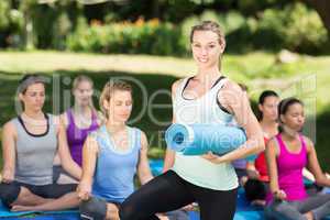 Fitness group doing yoga in park