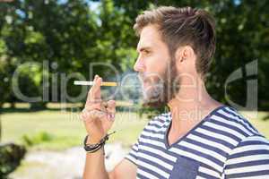 Hipster smoking electronic cigarette