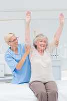 Nurse assisting female patient in exercising