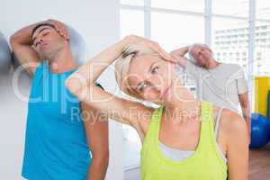 People doing neck exercise in fitness club