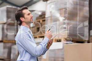 Warehouse manager checking his inventory