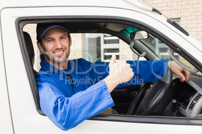 Delivery driver smiling at camera in his van