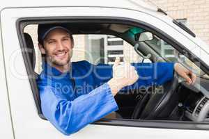 Delivery driver smiling at camera in his van