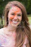 Young woman having fun with powder paint