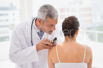 Doctor examining a spot at his patient