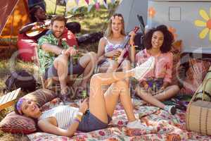 Happy hipsters relaxing on campsite