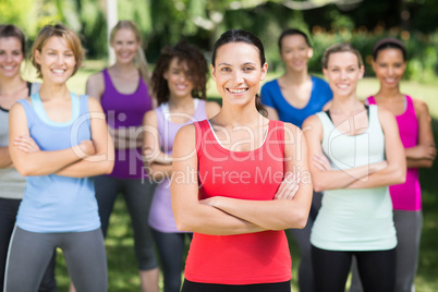 Fitness group smiling at camera in park