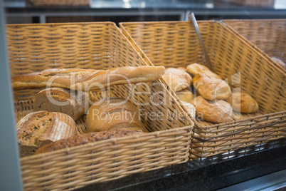 Baskets with breads freshly baked and tongs