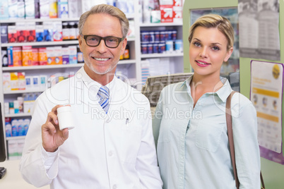 Pharmacist showing medicine jar