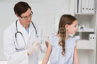 Doctor doing injection at a little girl