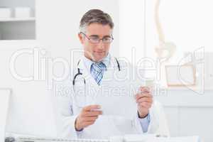 Doctor reading document in clinic