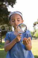 Curious little girl looking at leaf