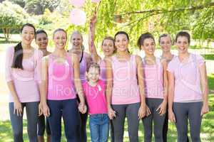 Smiling women in pink for breast cancer awareness