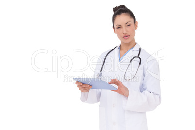 Focused doctor using her tablet pc