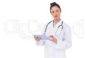 Focused doctor using her tablet pc