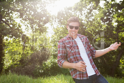 Handsome hipster playing air guitar