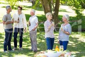 Happy family drinking in the park