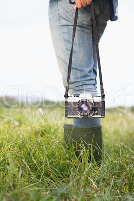 Woman in the park holding retro camera